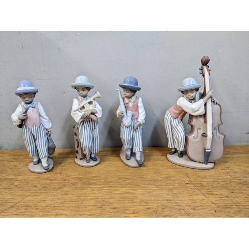 269 - Lladro porcelain musicians comprising boys playing a cello, saxophone, trumpet and clarinet
Location... 