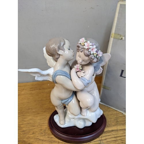 271 - A Lladro figure 'Heaven and Earth' on a cloud, hardwood base boxed
Location: R1.5