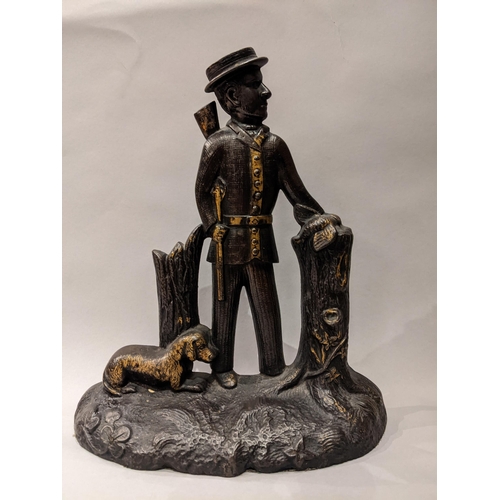 90 - An Edwardian painted and gilt, cast iron door stop in the form of a hunter with a gun, a dog at his ... 