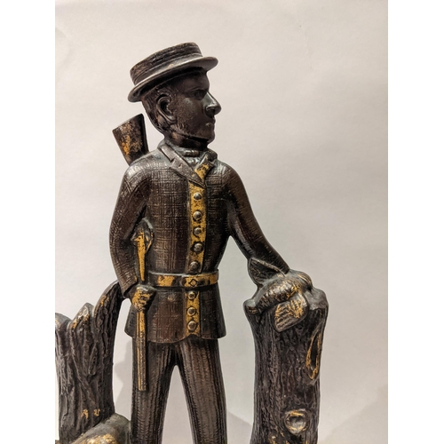 90 - An Edwardian painted and gilt, cast iron door stop in the form of a hunter with a gun, a dog at his ... 