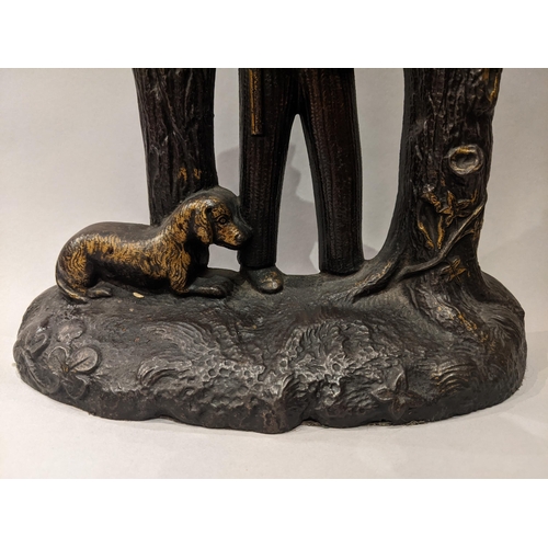 90 - An Edwardian painted and gilt, cast iron door stop in the form of a hunter with a gun, a dog at his ... 