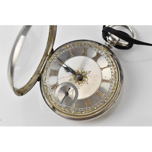 107 - A Victorian silver open faced pocket watch having an ornate silvered engraved dial with gilt highlig... 