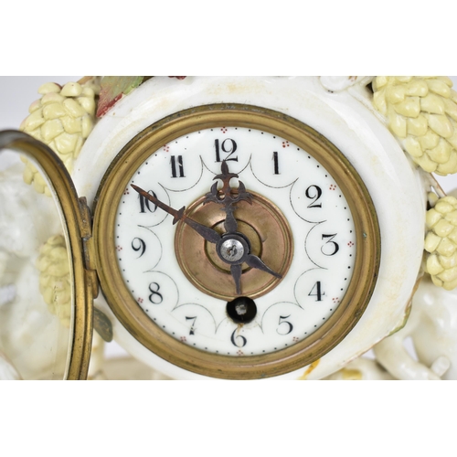 87 - A late 19th century porcelain mantle clock, decorated with cherubs eating grapes on a gilded base, t... 