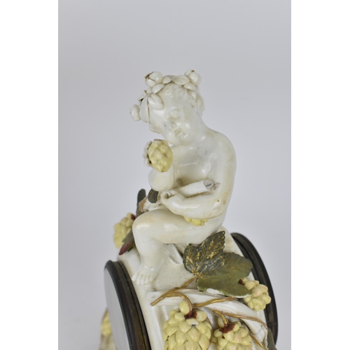 87 - A late 19th century porcelain mantle clock, decorated with cherubs eating grapes on a gilded base, t... 