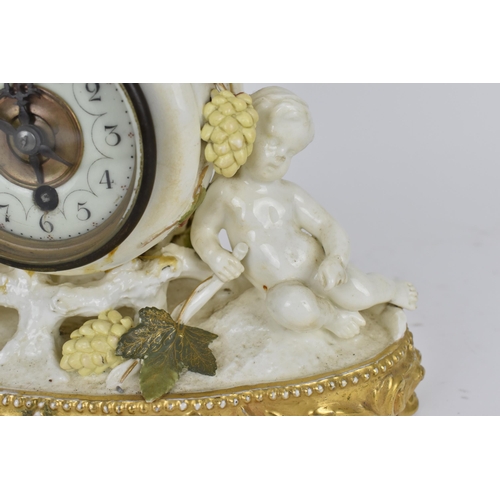 87 - A late 19th century porcelain mantle clock, decorated with cherubs eating grapes on a gilded base, t... 