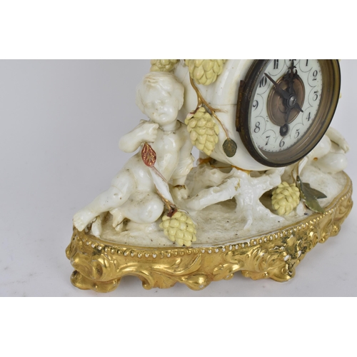 87 - A late 19th century porcelain mantle clock, decorated with cherubs eating grapes on a gilded base, t... 