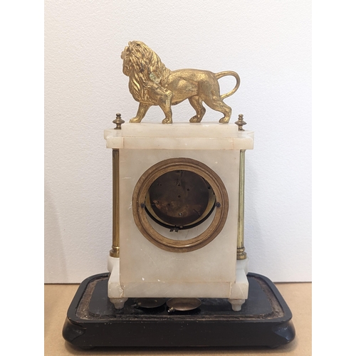 89 - A 19th century French white marble mantle clock with glass dome, the case decorated with gilt lion t... 