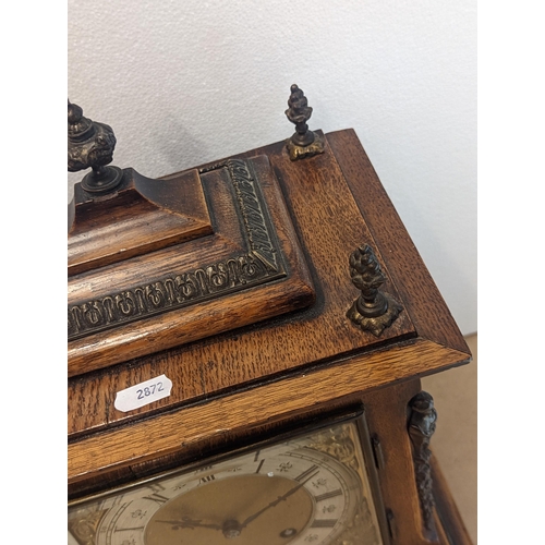 90 - A late 19th/early 20th century oak cased bracket clock, the case having five basket of grape finials... 