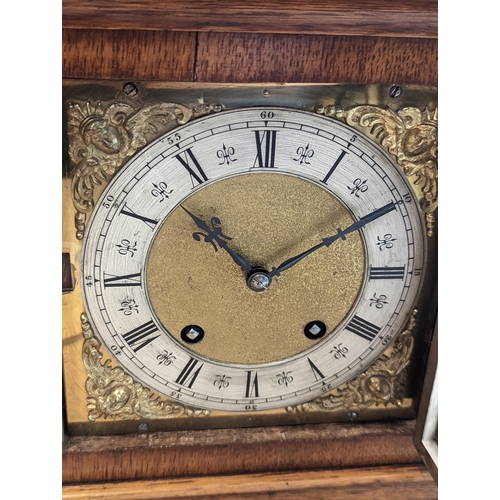 90 - A late 19th/early 20th century oak cased bracket clock, the case having five basket of grape finials... 