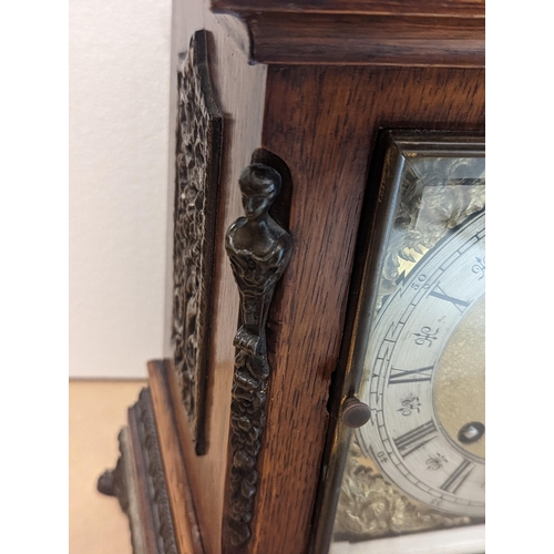 90 - A late 19th/early 20th century oak cased bracket clock, the case having five basket of grape finials... 