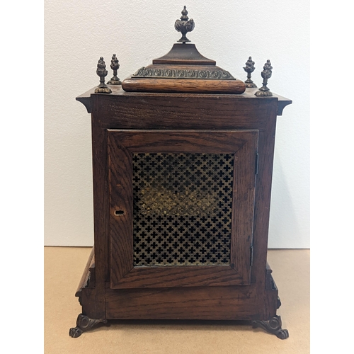 90 - A late 19th/early 20th century oak cased bracket clock, the case having five basket of grape finials... 