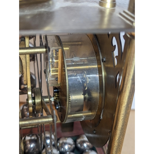 91 - A late 20th century Harding & Bazeley Spherical weight clock, limited edition no.444, the gilt metal... 