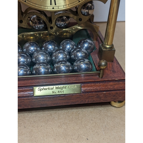 91 - A late 20th century Harding & Bazeley Spherical weight clock, limited edition no.444, the gilt metal... 