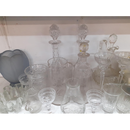 116 - A quantity of glassware to include four decanters with stoppers, an etched water jug and a Finnish b... 