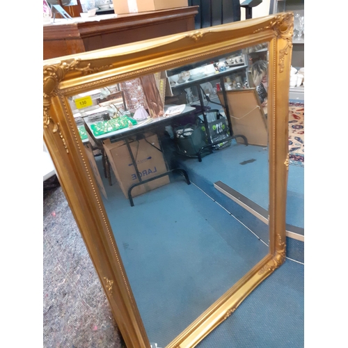 130 - A modern gold framed mirror, 119cm x 89cm 
Location: LAM