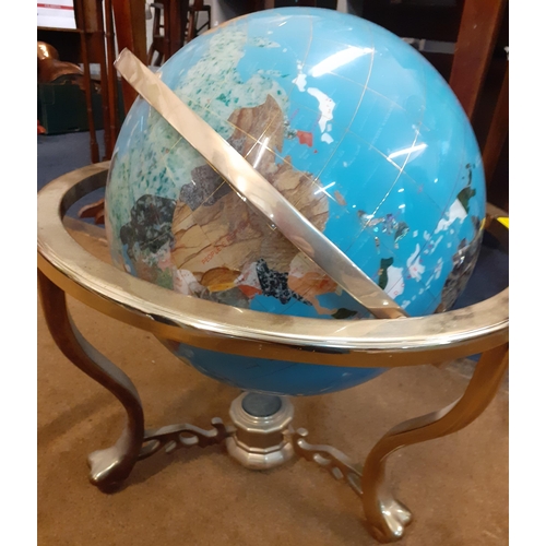 165 - A mineral terrestrial globe with inset mother of pearl and abalone in a brass coloured stand with co... 