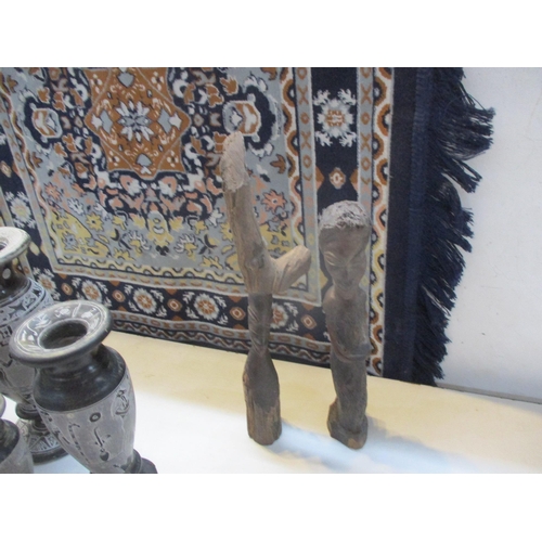 252 - A mixed lot to include wooden carvings, a small machine made blue ground rug signed Shilon, Egyptian... 