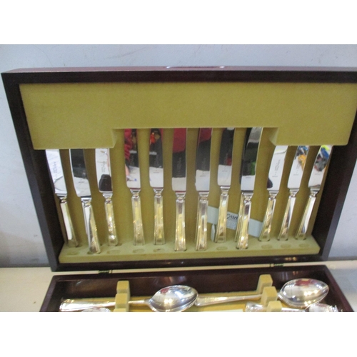 256 - A canteen of silver plated cutlery and flatware, eight place settings contained in a mahogany finish... 