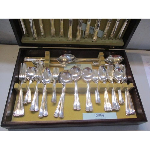 256 - A canteen of silver plated cutlery and flatware, eight place settings contained in a mahogany finish... 