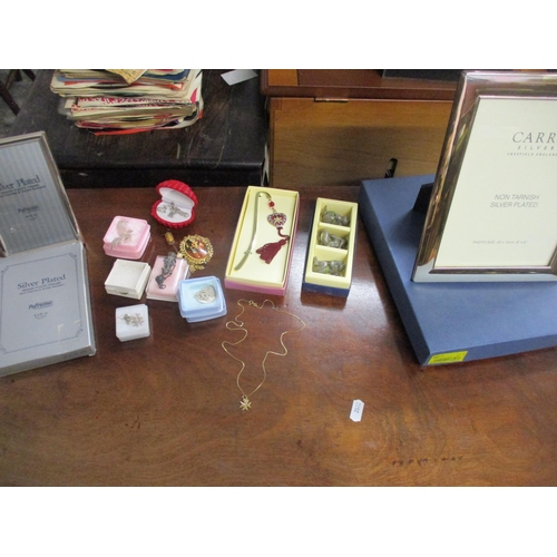 142 - A selection of jewellery, silver plated photo frames, and other items to include a 9ct gold necklace... 