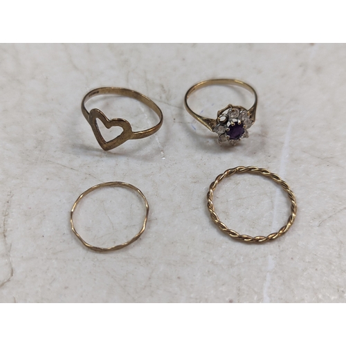 184 - A group of four rings to include two 9ct gold examples, one stamped 9ct, and one yellow metal exampl... 