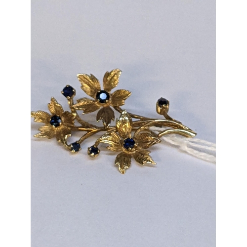 12 - A gold brooch fashioned as a flower, set with sapphires, tested as 9ct, 4.8g
Location: CAB5