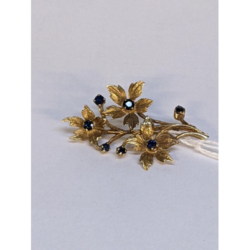 12 - A gold brooch fashioned as a flower, set with sapphires, tested as 9ct, 4.8g
Location: CAB5