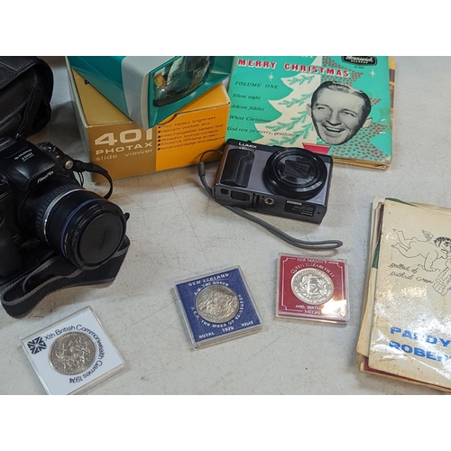 179 - A mixed lot to include a Lumix Panasonic DC-TZ90, a Fujifilm Fine Pix and 401 Photax, commemorative ... 