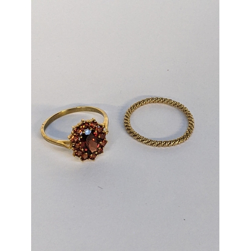 18 - A 9ct gold cluster ring inset with a garnet, together with a yellow metal band, 1.25g
Location: CAB4