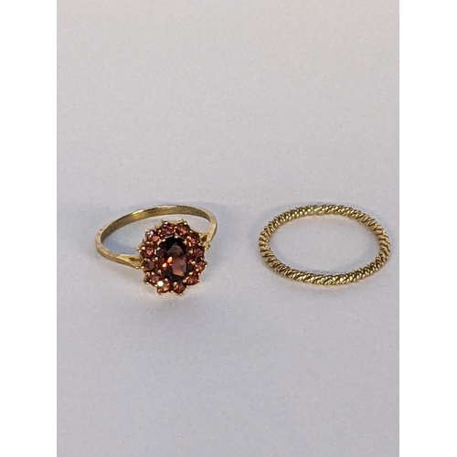 18 - A 9ct gold cluster ring inset with a garnet, together with a yellow metal band, 1.25g
Location: CAB4