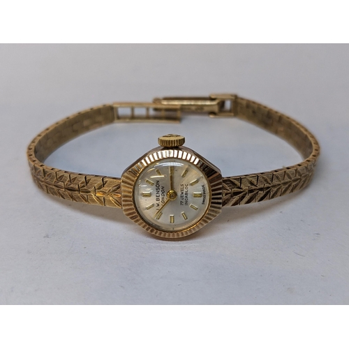 201 - A 9ct gold vintage ladies J.W Benson manual wind wristwatch on a 9ct gold bracelet, 14.8g
Location: ... 