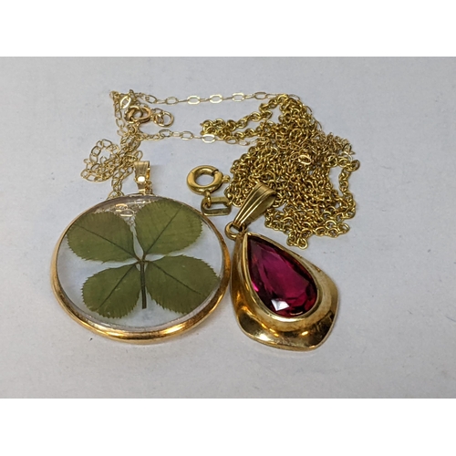 206 - A 9ct gold necklace with a pendant inset with a four leaf clover, together with a 14ct gold necklace... 