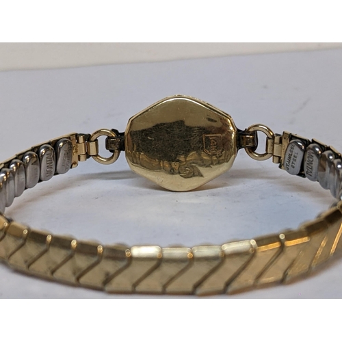 215 - A 14ct gold ladies watch on a gold plated expanding bracelet
Location: CAB5