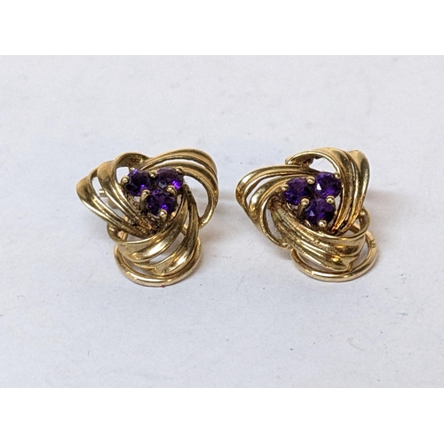 216 - A pair of yellow metal earrings, each inset with three amethysts, 3.5g
Location: CAB3