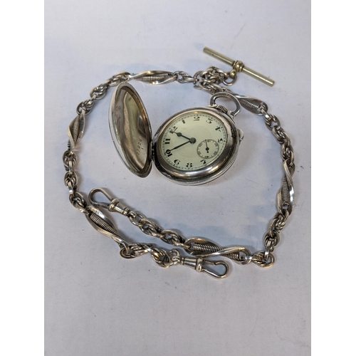 223 - An early 20th century silver fob watch by Talis Watch Co, the front decorated with a golfer, 54.3g, ... 