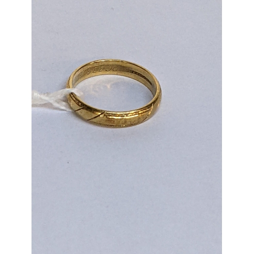 4 - A 18ct gold wedding ring with engraved ornaments, 3.8g
Location: RING