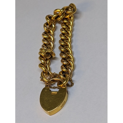 56 - A 15ct gold bracelet with heart shaped locket, 18.9g
Location: CAB1