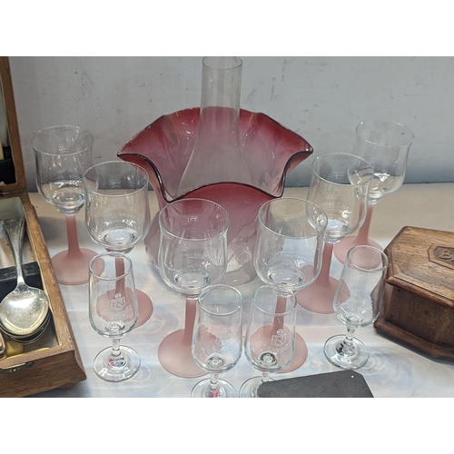 76 - A mixed lot to include white wine glasses, Domecq glasses, a pink glass lamp shade, a canteen of cut... 