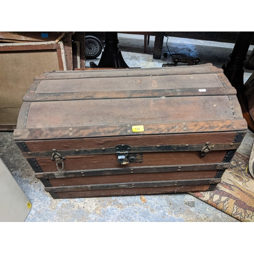 134 - A mixed lot to include a vintage dome-topped and canvas clad trunk, a folding card table, mixed pict... 