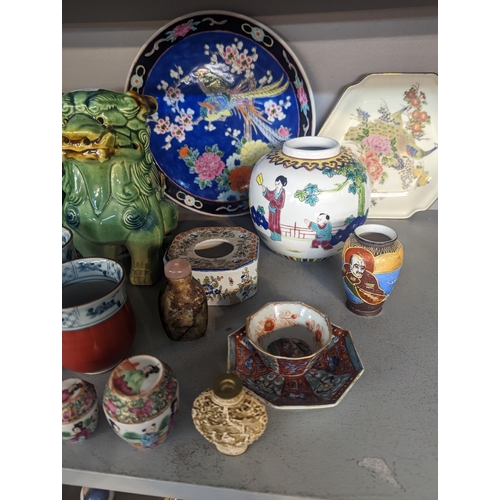 334 - A mixed lot of Oriental ceramics and figures to include tea bowl and saucer, ginger jar, model eleph... 