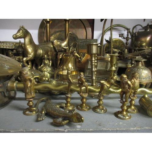 163 - A quantity of brassware to include various lady tea bells, desk bells and others, horse brasses, a p... 