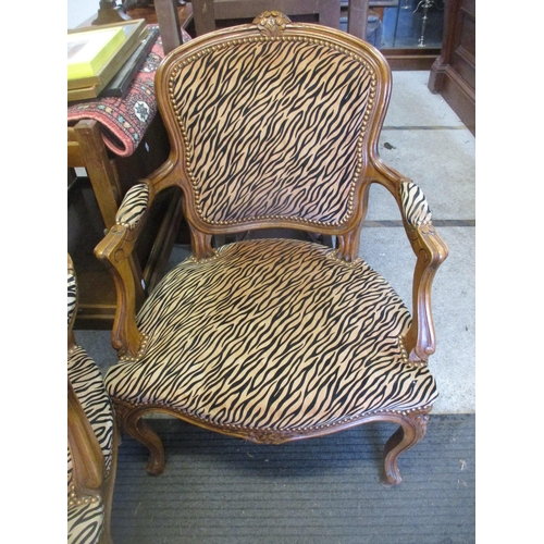 361 - Two reproduction French style walnut armchairs upholstered in a tiger pattern fabric (upholstered ap... 