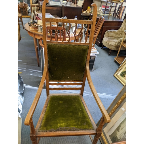 410 - An Arts & Crafts oak armchair, possibly by J S Henry, having scroll terminals and stud back upholste... 