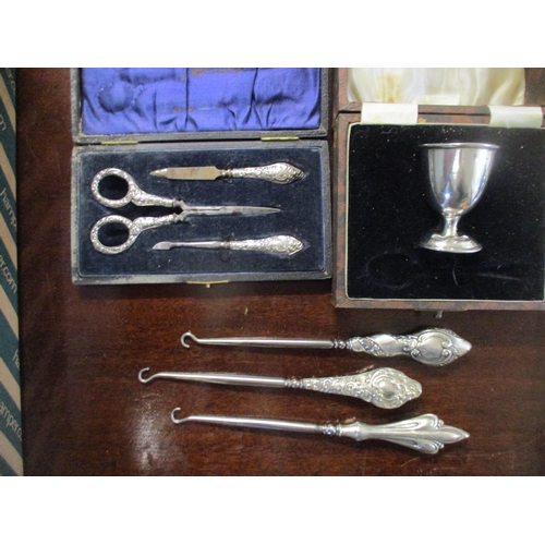 467 - Silver to include clad, glass condiment, silver condiments, silver handled button hooks, manicure se... 