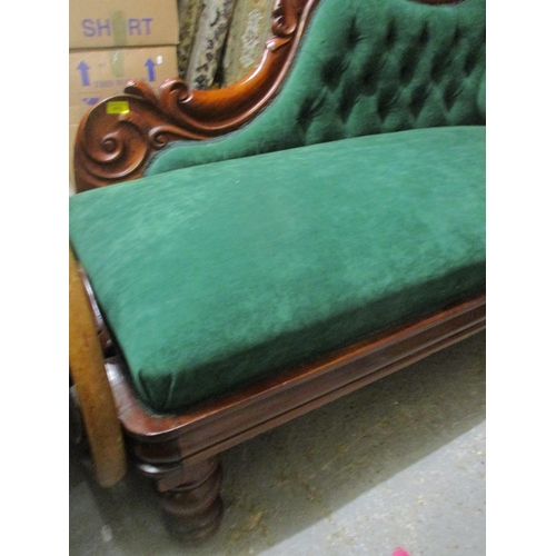 470 - A Victorian carved mahogany framed chaise longue, button back upholstery in green, on turned legs 85... 