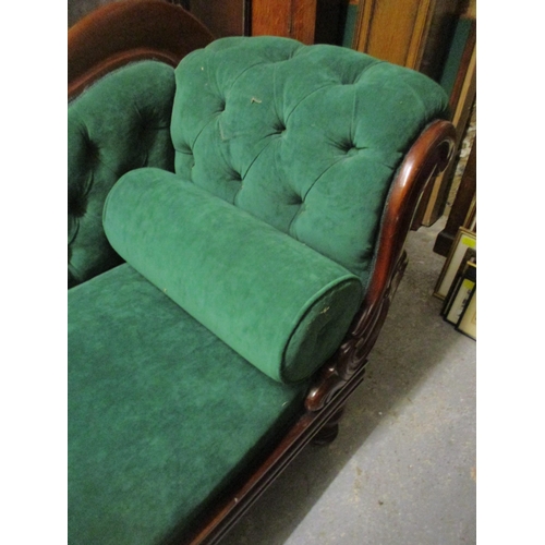 470 - A Victorian carved mahogany framed chaise longue, button back upholstery in green, on turned legs 85... 