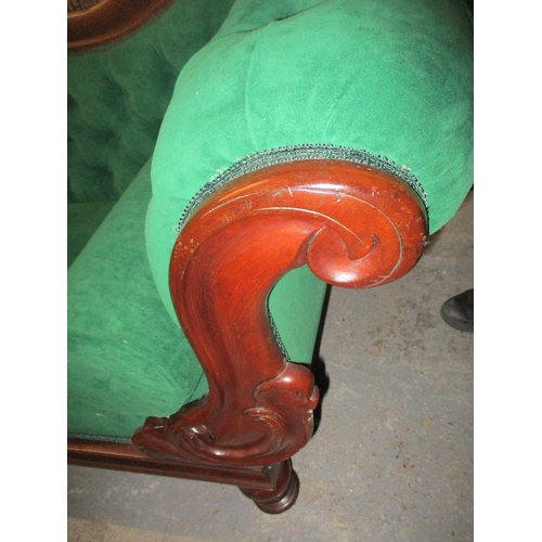 470 - A Victorian carved mahogany framed chaise longue, button back upholstery in green, on turned legs 85... 