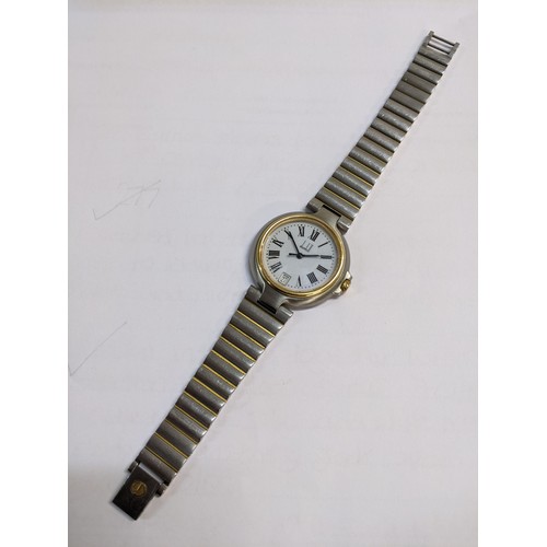 50A - A Dunhill quartz bi-coloured metal wristwatch having a white enamel dial with Roman numerals and dat... 