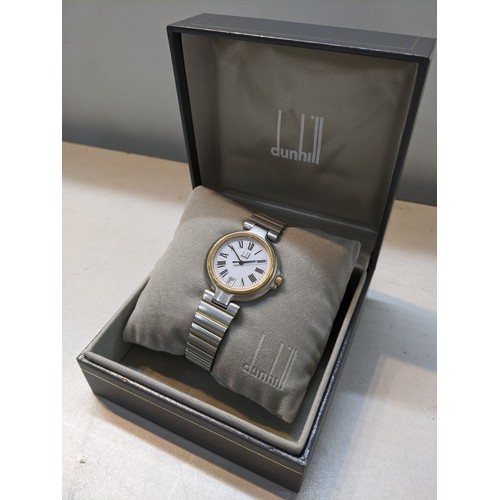 50A - A Dunhill quartz bi-coloured metal wristwatch having a white enamel dial with Roman numerals and dat... 