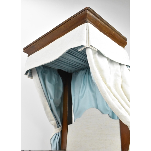 27 - A 19th century doll's half tester bed, with upholstered bed hangings and headboard, on turned feet, ... 